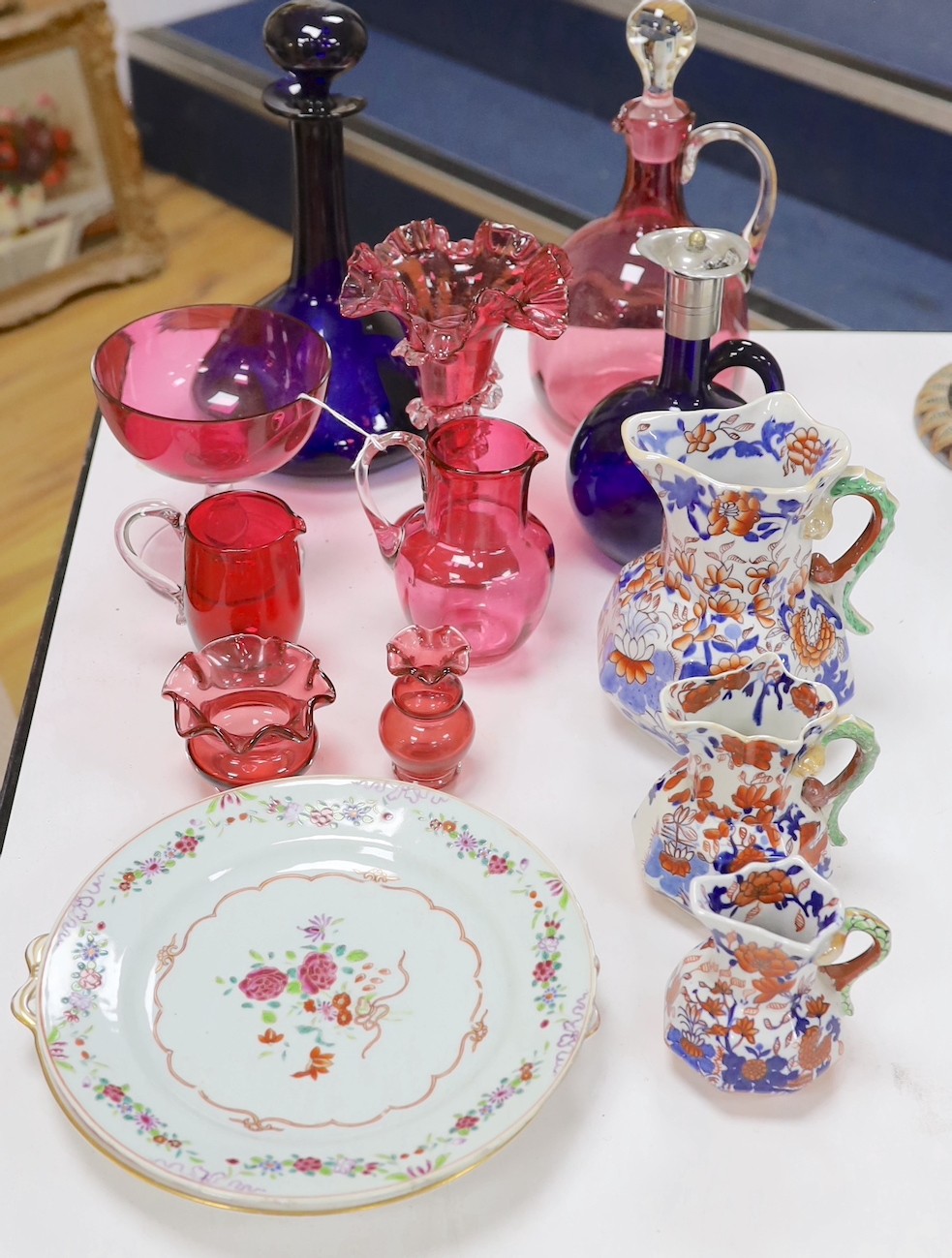 An assortment of cranberry glassware, graduated Masons Ironstone jugs, Chinese export plates etc.